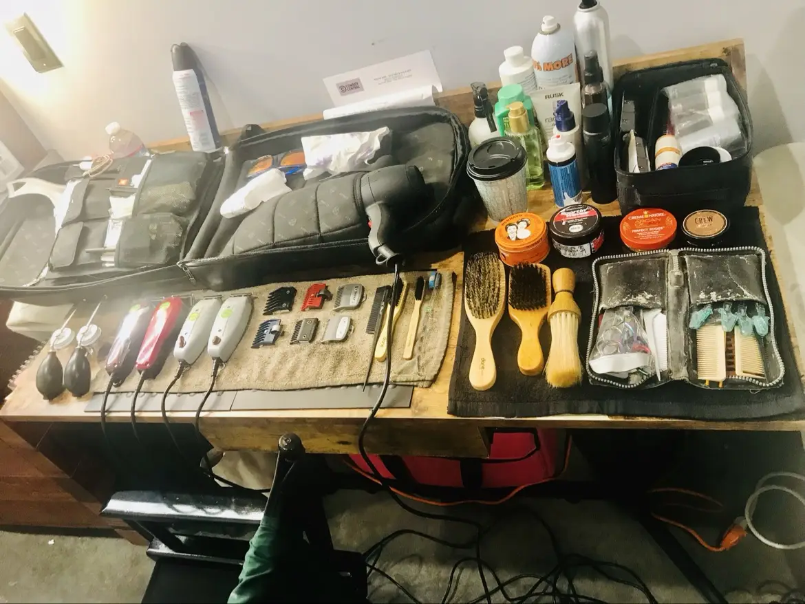 Tools laid out in order on the station — clippers in a row, brushes, guards and kit